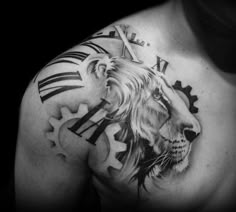 a man's chest with a lion and gears tattoo on it