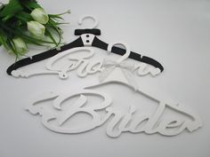 the bride and groom hangers are made out of acrylic paper, with flowers in the background