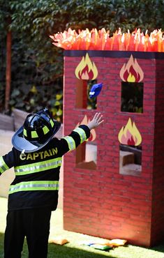 a young boy dressed as a fire fighter