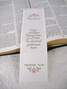 a cross stitch bookmark with the bible verse on it's front and back