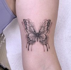 a small butterfly tattoo on the right thigh and lower leg, it is black and white