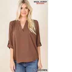 Stay Stylish And Warm This Season With This Women's Wool Dobby Blouse With Button Sleeves. Made With A Soft And Cozy Wool Dobby Fabric, This Blouse Features A Classic Button-Sleeve Design For A Versatile Look. The Relaxed Fit And Round Neckline Create A Comfortable And Flattering Silhouette, Making It A Great Choice For Both Work And Play. Available In Various Colors, This Wool Dobby Blouse Is A Must-Have For Any Winter Wardrobe. Brown V-neck Blouse For Office, Brown V-neck Blouse With Button Closure, Casual Brown Blouse For Office, Casual Brown Office Blouse, Casual Brown Top For Office, Casual Brown Office Top, Light Blue Blouse, Dobby Fabric, Flowy Shirt