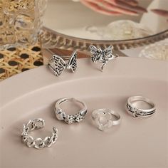 These shimmering silver-plated rings bring quirky style to your look and are a versatile addition to your everyday jewelry collection. Includes butterfly ring, chain ring, snake ring, dice ring, celestial ring and flower ring (six pieces total) Sizes range from 6 to 7 Higest face: 0.71" H Silver-plated copper Dice Ring, Card Rings, Daisy Rings, Love Rings, Crying Face, Fairy Ring, Celestial Ring, Quirky Style, Chain Rings