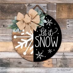 a wooden sign that says let it snow with a bow on the front and side