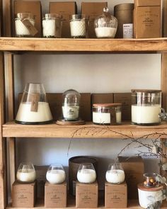 the shelves are filled with different types of candles