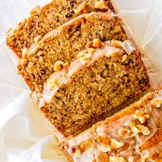 slices of cake sitting on top of a white plate with frosting and nuts around it