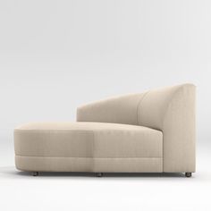 a beige couch sitting on top of a white floor