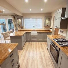 a kitchen with wooden floors and gray cabinets