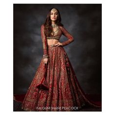 a woman in a red and gold lehenga