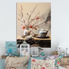 a table topped with vases filled with flowers next to pillows and other decor items