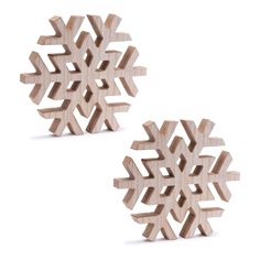 two wooden snowflakes sitting next to each other on top of a white surface