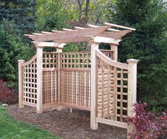 a wooden gazebo in the middle of a garden