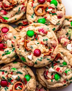 a pile of cookies with candy and pretzels on top