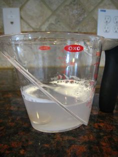 a measuring cup filled with liquid on top of a counter