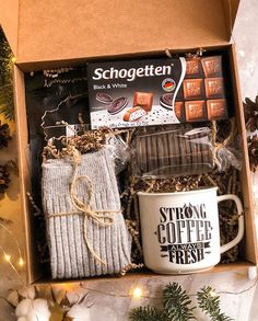 an open box containing coffee, socks and mug