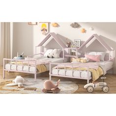 two children's beds with pink frames and white sheets in a child's room