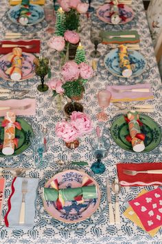 the table is set with colorful plates and napkins