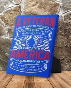 a blue book sitting on top of a wooden table next to a stone wall with the words, a veteran is wrote at one point in their life