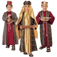 three children dressed up in medieval clothing and holding items from around the world for halloween