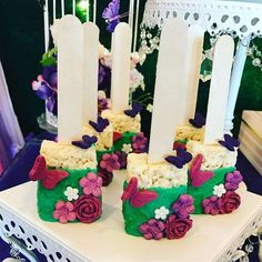 there are four candles that have flowers on them, and one is made out of rice