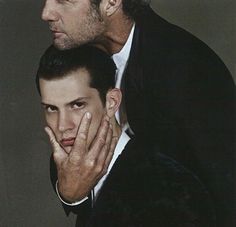 two men are posing for the camera with one holding his hand on his face while the other holds his head