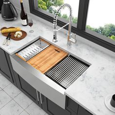 a stainless steel kitchen sink with wooden cutting board