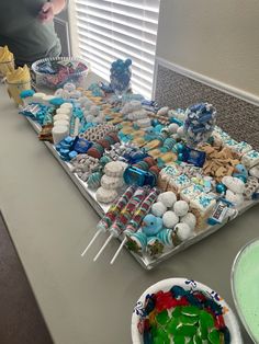 a table topped with lots of different types of cakes and desserts on top of it