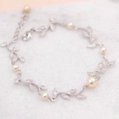 Our vine Crystal Bracelet is a perfect way to addto your wedding day jewelry featuring Swarovski crystals.    The CZ crystals are very high quality.  Set in a rhodium tarnish resistant base,  we have closed it with a lobster clasp and small extender complete with a matching crystal for final fit. Measurements: requested at checkout 💞 All our jewelry is presented in velvet pouches and high quality elegant, padded boxes ready for gifting 💝 ★Shopping for your bridal party? Contact us for special Silver Cubic Zirconia Pearl Bracelet For Anniversary, Dainty Silver Crystal Bracelet For Wedding, Dainty Crystal Bracelet For Wedding, Silver Cubic Zirconia Bracelet For Bridesmaid, Dainty Cubic Zirconia Crystal Bracelet For Wedding, Dainty Crystal Wedding Bracelet, Elegant Crystal Bracelet For Bridesmaids, Silver Pearl Crystal Bracelet For Wedding, White Crystal Diamond Bracelet For Wedding