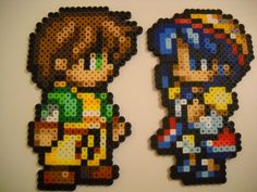 two pieces of perler bead art on a white surface, one with an image of mario and luigi