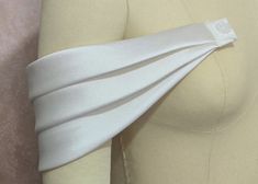 the back of a woman's dress with a white sash on it