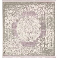 an area rug with a medallion design on the front and side, in light purple tones