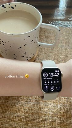 an apple watch on someone's arm next to a cup of coffee with the message coffee time