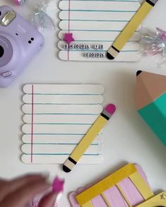 some school supplies are laid out on a table with pencils and eraser pens