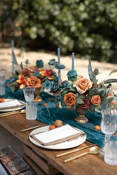 the table is set with flowers and place settings