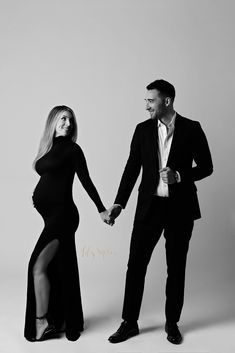 a man and woman holding hands while standing in front of a white background with the caption's name on it