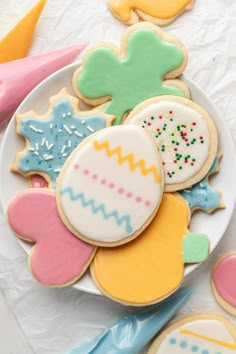 decorated sugar cookies on a plate with colorful icing