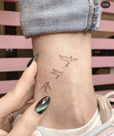 a woman's neck with three birds on it