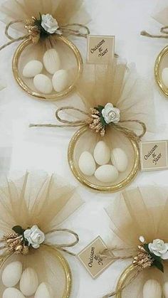 there are eggs in small baskets with flowers on the top and tags attached to them