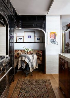 a kitchen with an oven and table in it