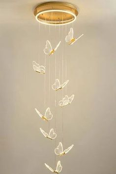 a chandelier with butterflies hanging from the ceiling