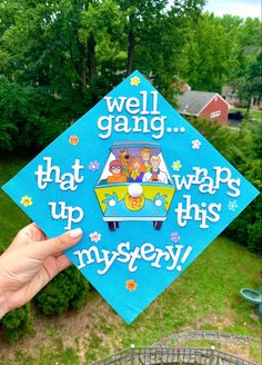 someone holding up a blue graduation cap with the words well gang that wraps up this mystery