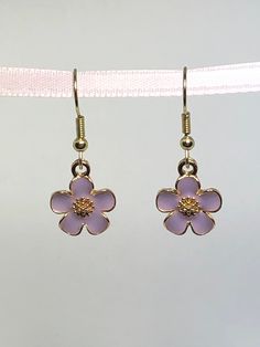 These small, cute flower charms measure approx. .5" round. Total drop length is approx. 1.75" I will ship USPS First Class mail please keep in mind this ALWAYS includes a TRACKING number. You will be notified via Etsy with tracking information. A satisfied customer is my goal and a five-star review is appreciated, if you have any problems or issues with your purchase or you are not 100% Happy, please contact me. Keep in mind I do not accept returns at this time, but I am willing to work with you to solve any issues that may occur with a purchase. THANKS FOR STOPPING BY! Metal Flower Charm Earrings For Spring, Metal Flower Charm Earrings, Pink Flower Metal Earrings, Pink Flower-shaped Metal Earrings, Cute Gold Flower Charm Earrings, Purple Flower Charm Earrings, Metal Flower Charm Drop Earrings, Metal Flower Charm Earrings As Gift, Metal Drop Earrings With Flower Charm