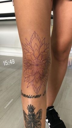 a woman's leg with a tattoo on it and a butterfly in the middle