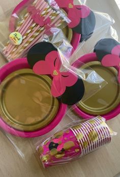 pink and black minnie mouse party supplies on a table