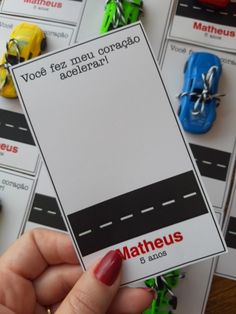 a person holding up a card with cars on it