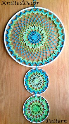 two circular crocheted doily hangings on a wooden table