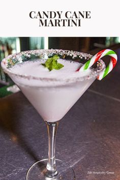 a martini with candy cane garnish on the rim