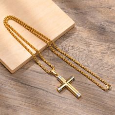 The cross, a timeless symbol of devotion and spirituality, takes on a new level of sophistication with this exquisite piece. Crafted with durable stainless steel, it is built to withstand the test of time, just like your unwavering faith. The combination of gold and silver tones adds a touch of elegance and versatility to the necklace. The warm glow of gold represents the divine light that guides your path, while the cool silver hue symbolizes purity and resilience. Wear it close to your heart, and let its presence remind you of the strength and grace that lie within you.Weight: 15.13 gWidth: 30 mmHeight: 46.5 mmMaterial: Stainless SteelPlating Color: Silver, Yellow Gold Cross Accessories, Gold Chain Design, Gold Chains For Men, Divine Light, Holy Cross, Jewelry Lookbook, Cross Design, Mens Pendant, Cross Jewelry