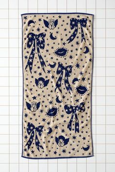 a blue and white towel with stars on it, hanging from the side of a tiled wall