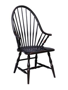 a wooden chair with black leather seat and armrests on an isolated white background